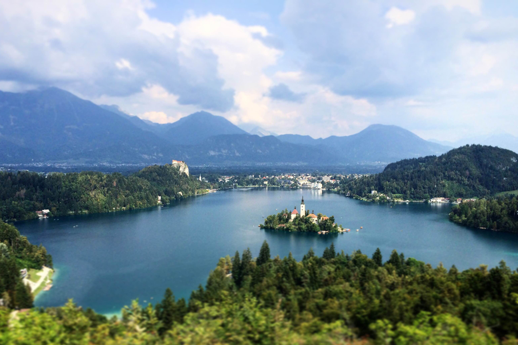 Panoramic view of mountains and a small island in a blue lake