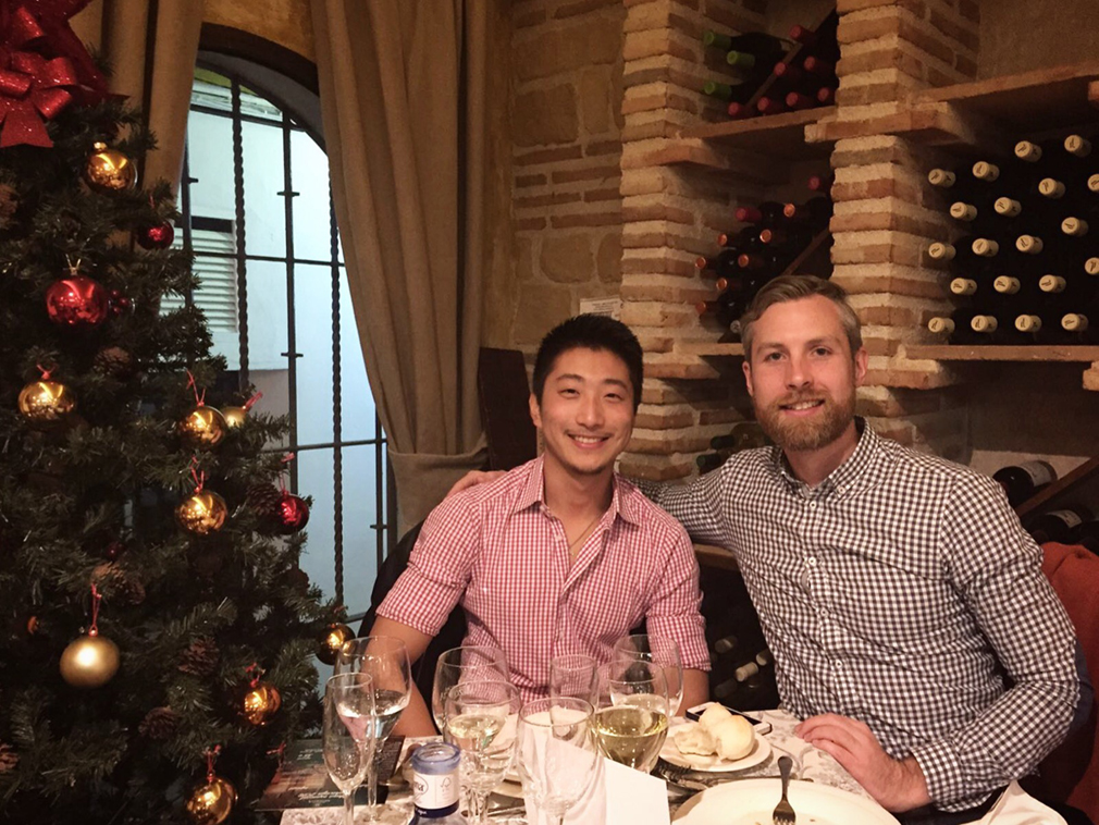 A couple in gingham shirts posing for Christmas dinner