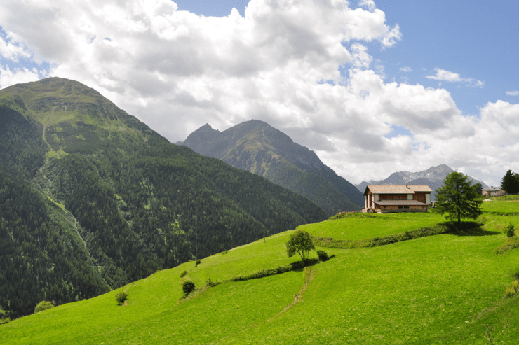 Wooden cabin above a forested valley