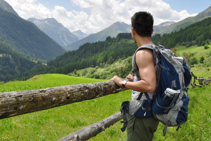 Man with backpack admiring mountain scenery