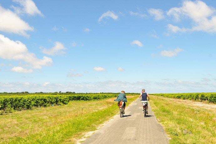 Two men cycling down a country road