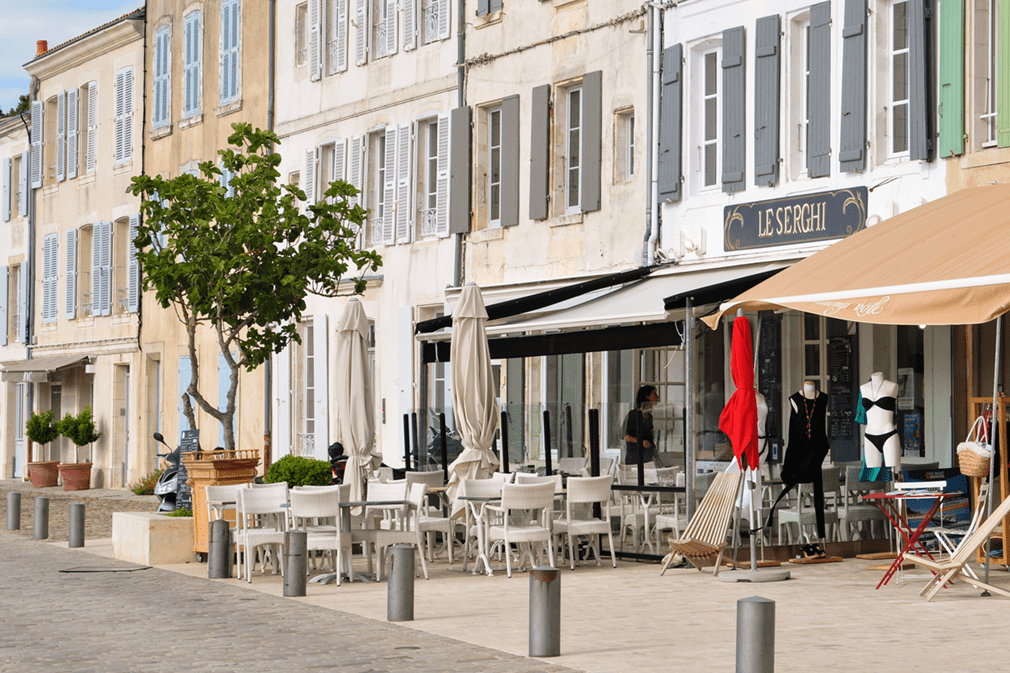 Quayside of village with colorful old buildings and boutiques and restaurants