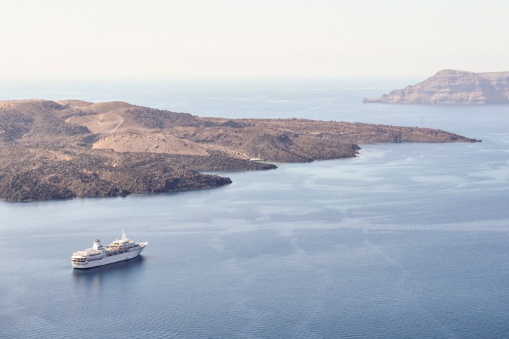 Cruise ship sailing past arid island
