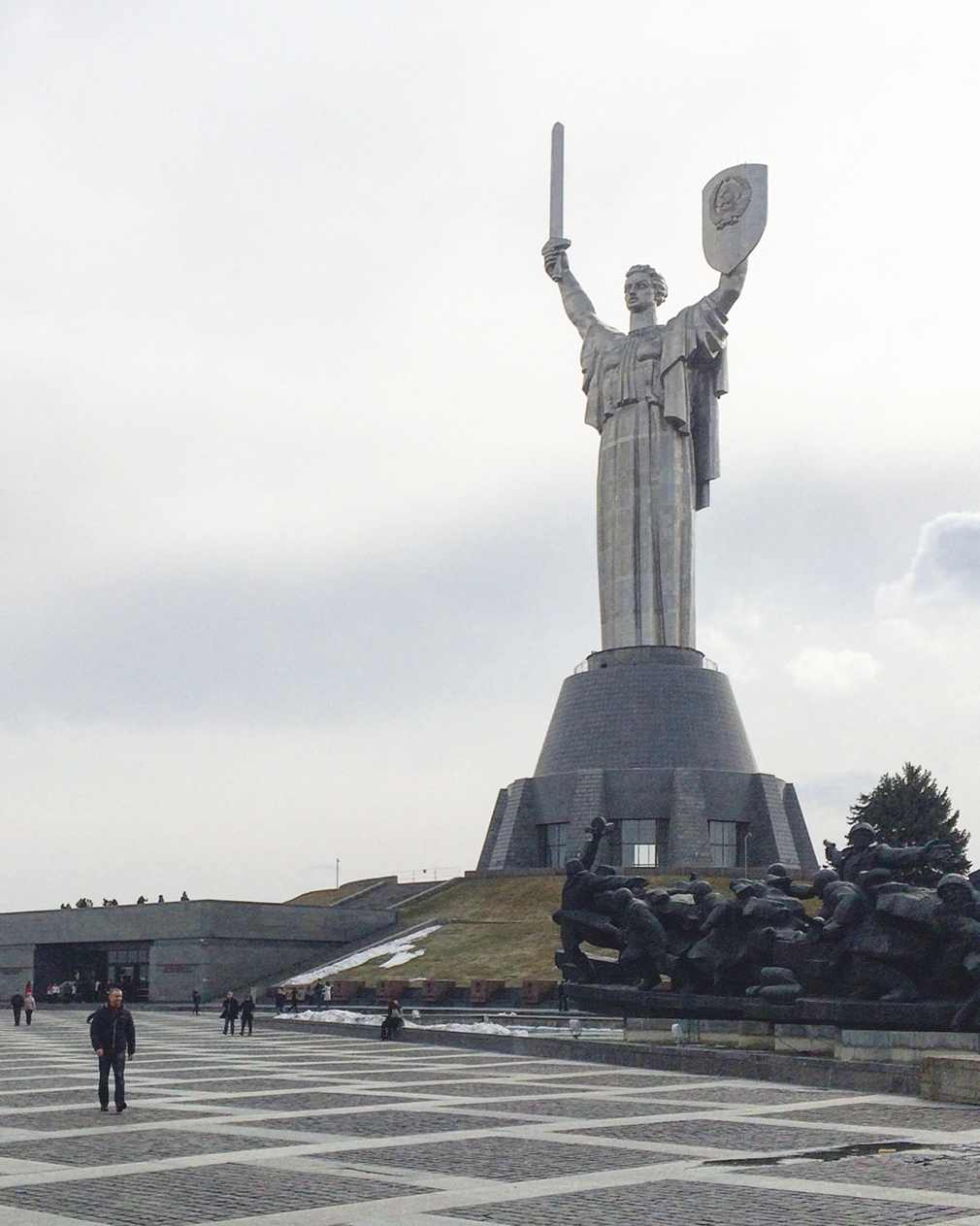 Large monument of woman draped in frock holding sword and shield