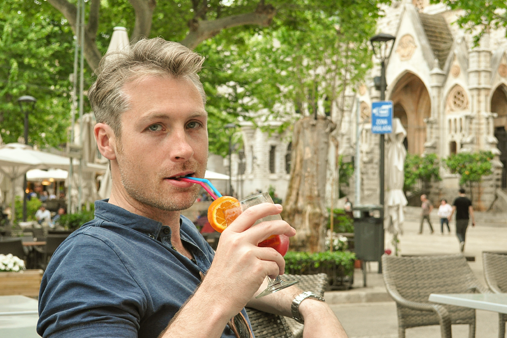 Man sipping sangria in front of a church
