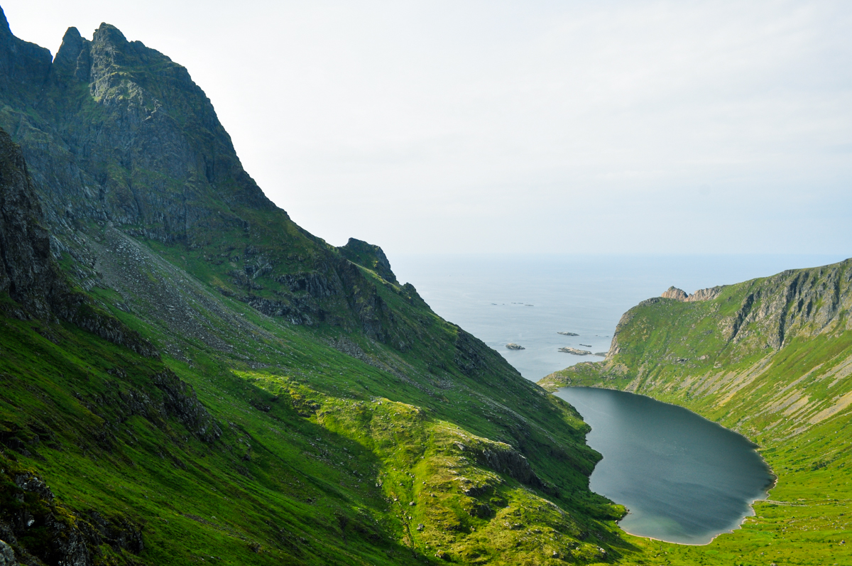 A lake at the base of a mountain by the sea