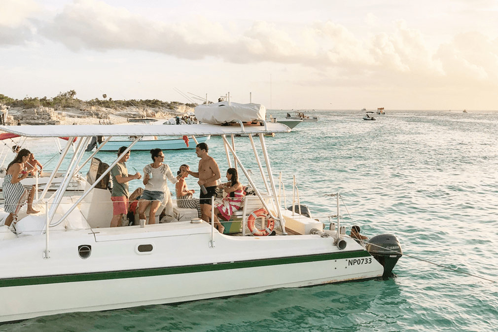 Holidaymakers on a boat at sunset