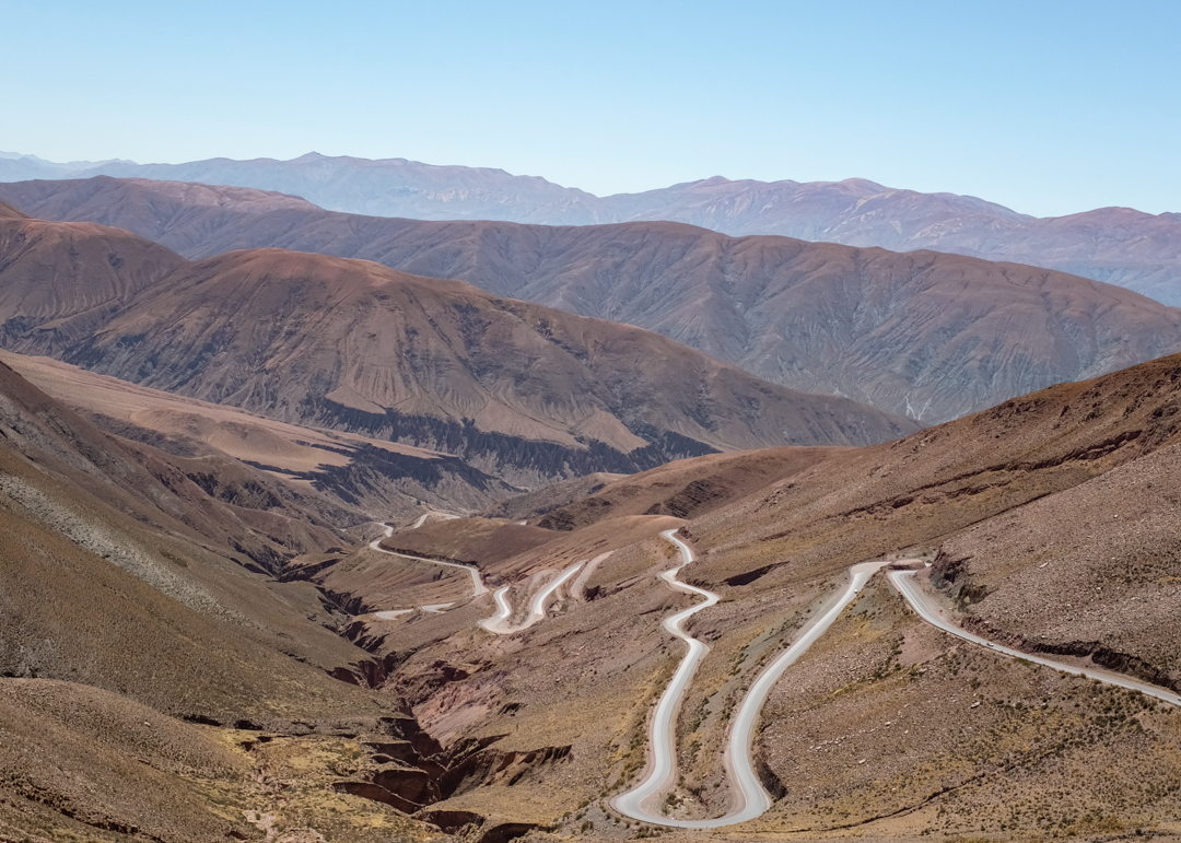 A winding road zigzagging up a canyon