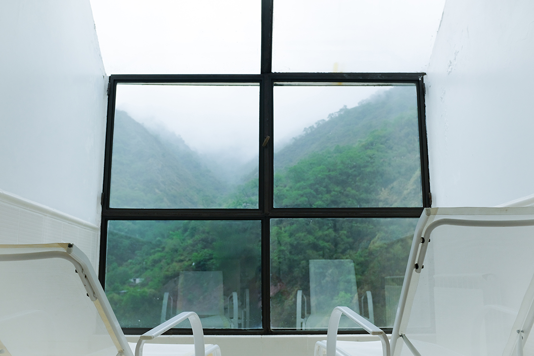 View of a jungle landscape from the interior of a spa