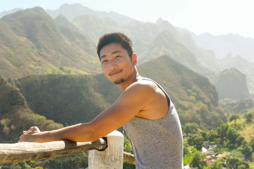 Man posing in front of mountain scenery