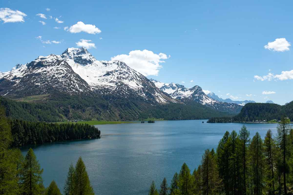 Panorama of a large mountain lake surrounded by forest