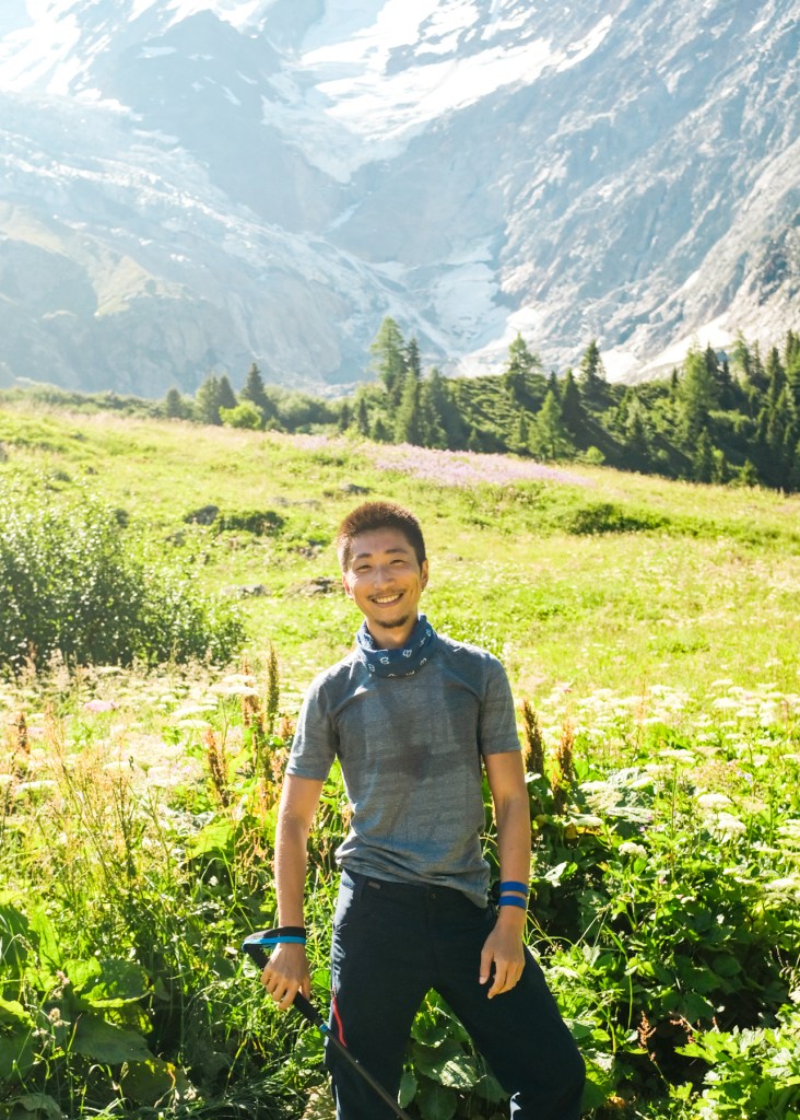 Smiling man posing in front of a glacier