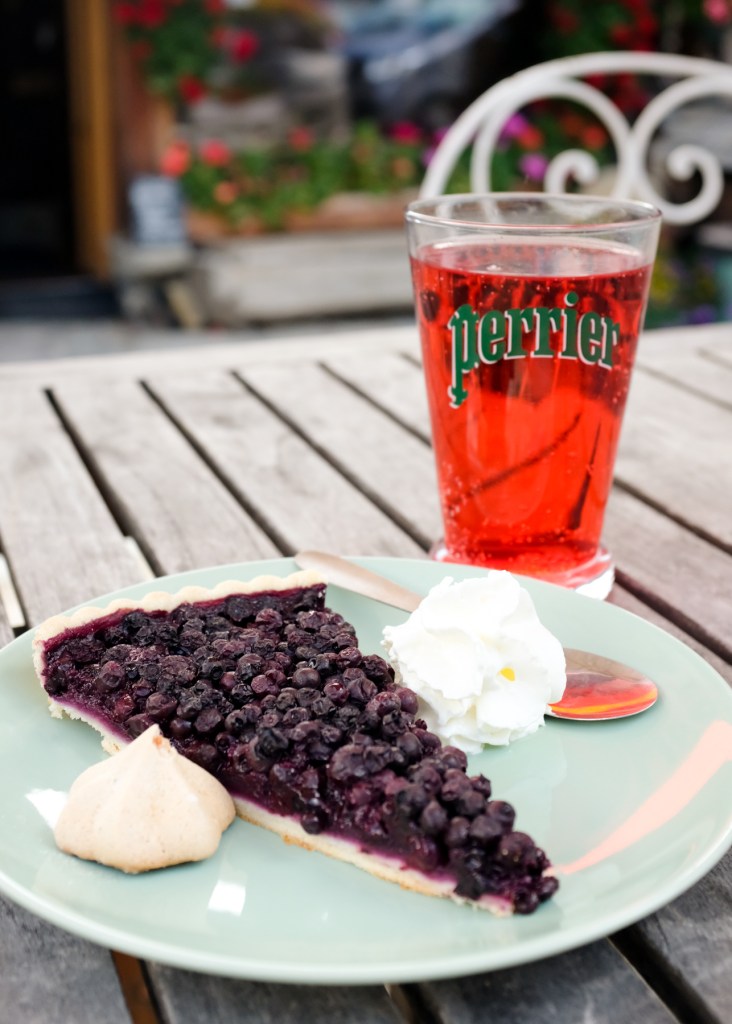 Close-up of a blueberry pie and strawberry soda