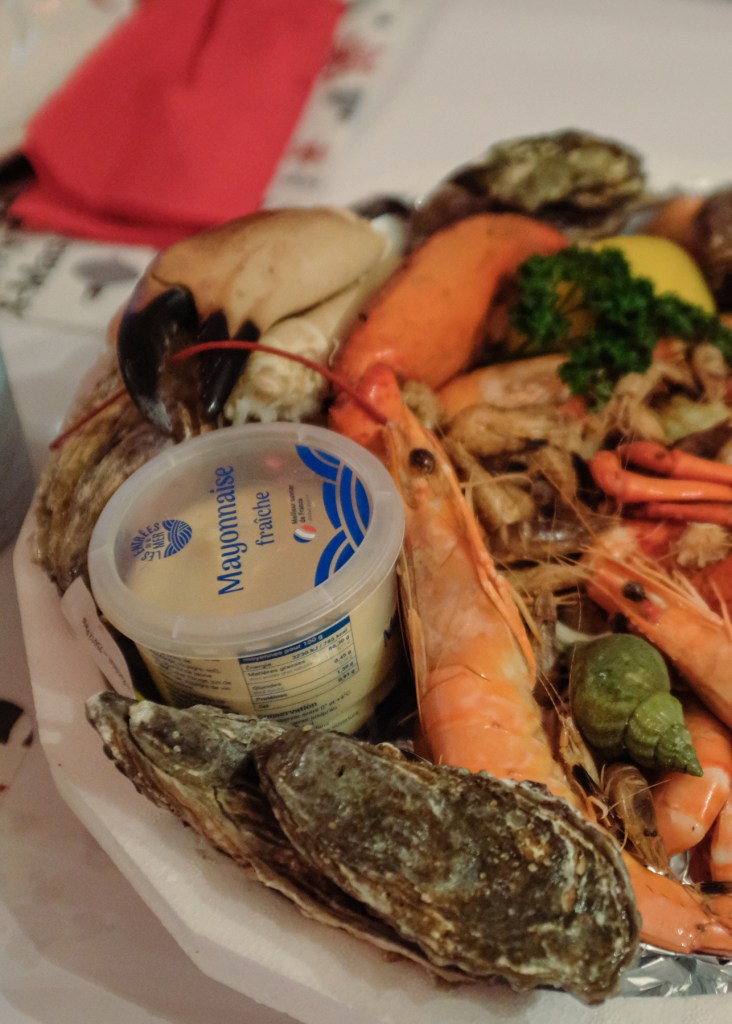 A platter of oysters, shrimp, crabs, and whelks