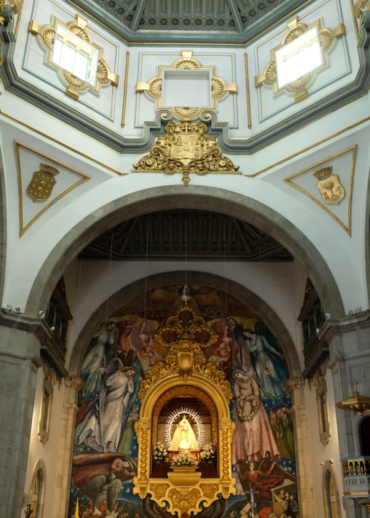 The inside of a basilica featuring a Black Madonna