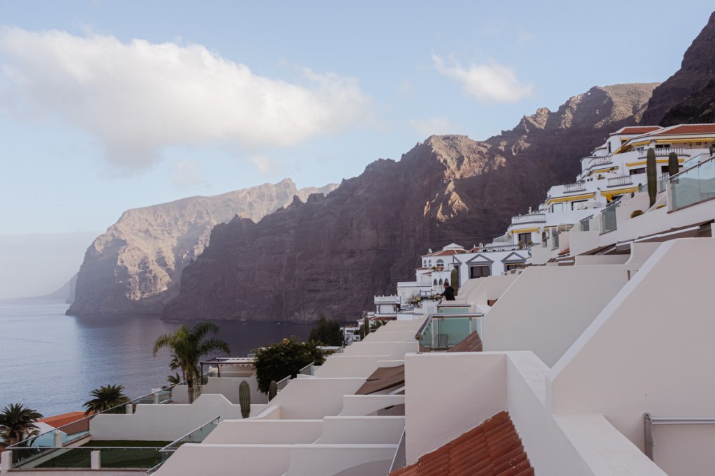 The view of large cliffs from the balcony of a resort complex