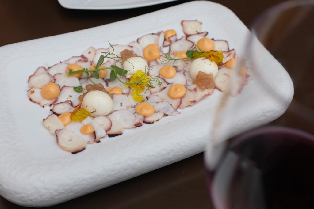 Octopus carpaccio with smoked paprika and saffron oil, paired with a glass of the local Tinerfeño wine