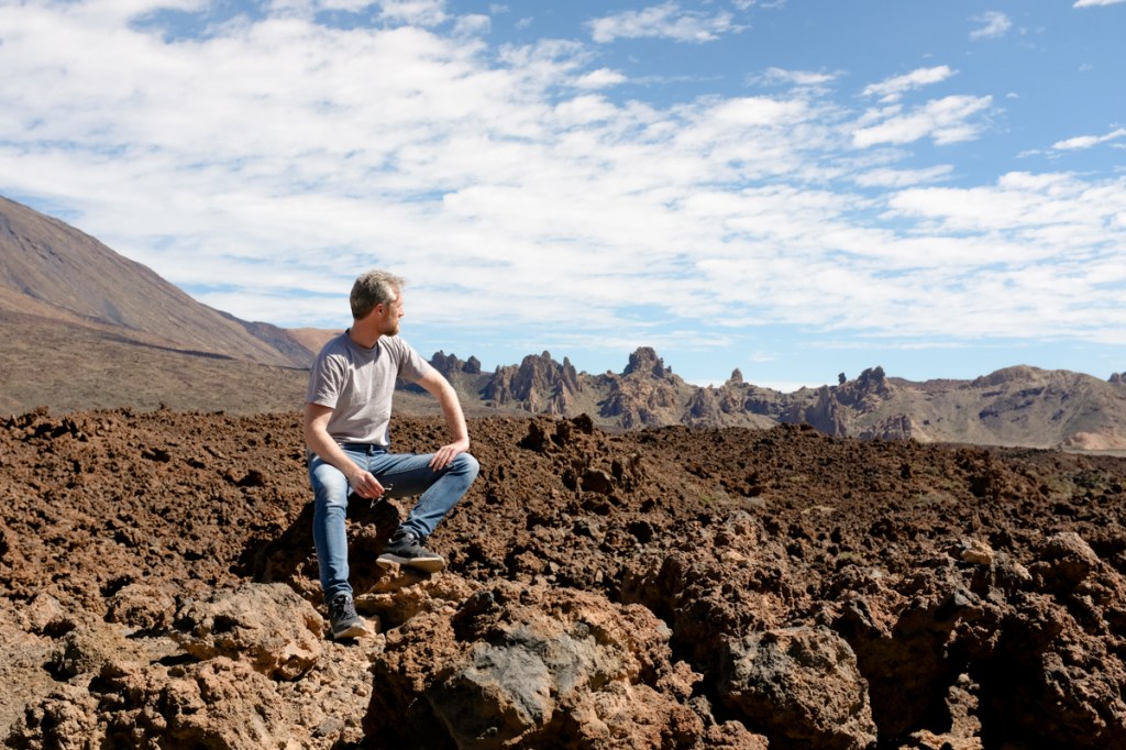 Man looking at jagged rock formations