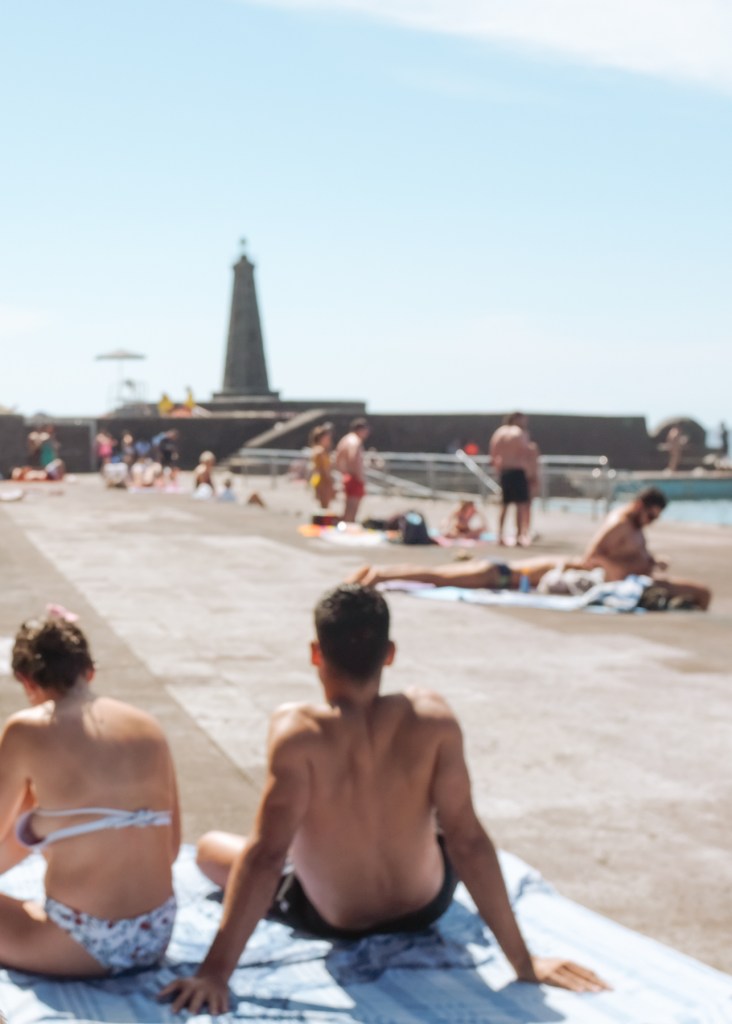 A couple sunbathing at a public pool