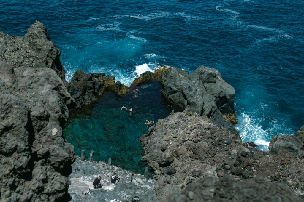 Swimmers enjoying a natural rock pool