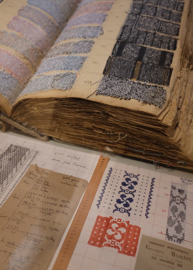 A collection from the Basque Museum in Bayonne displaying traditional cloths and patterns such as the lauburu, or Basque cross
