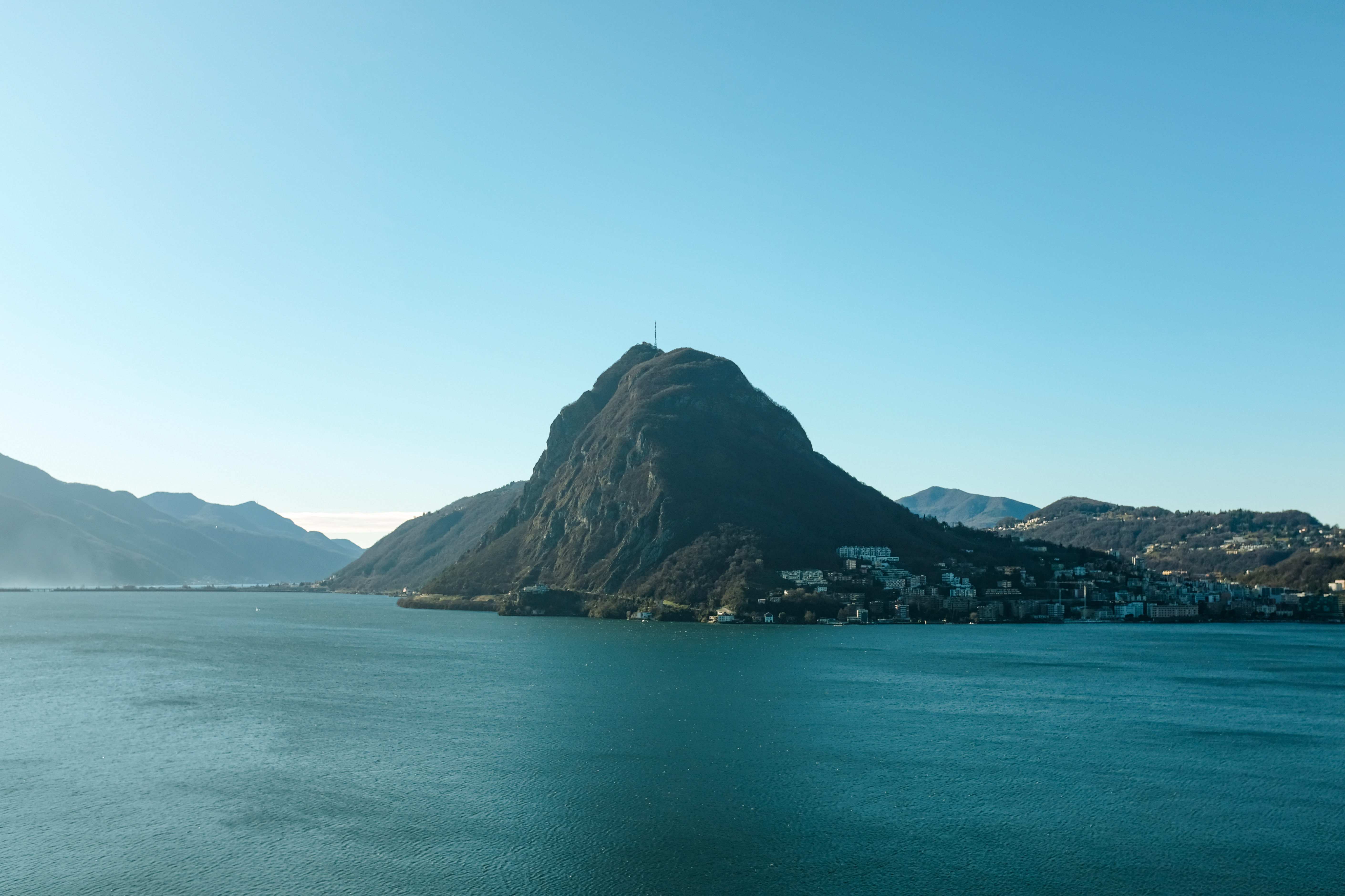 A mountain surrounded by a large lake