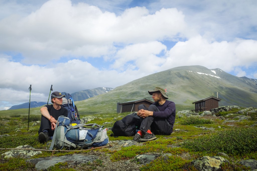 Two hikers taking a break in the mountains