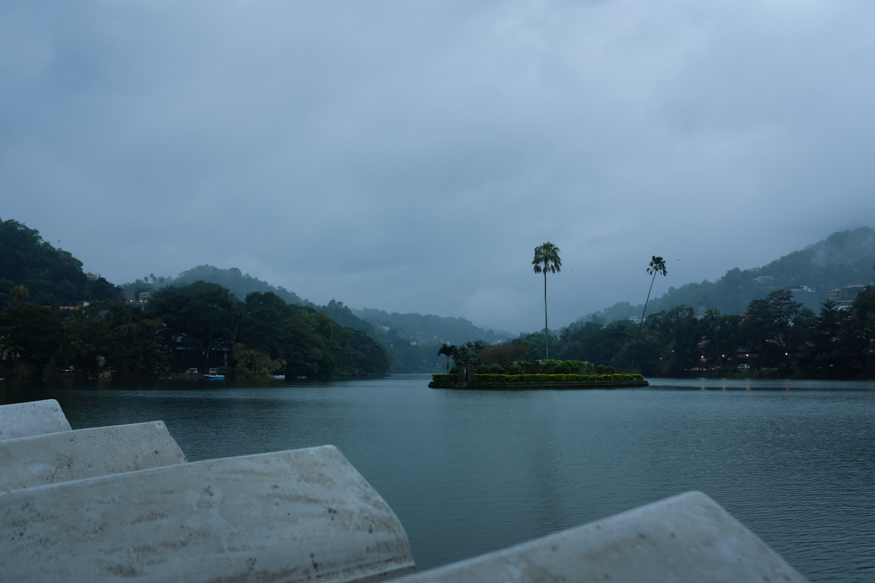 A small artificial island in a lake at dusk